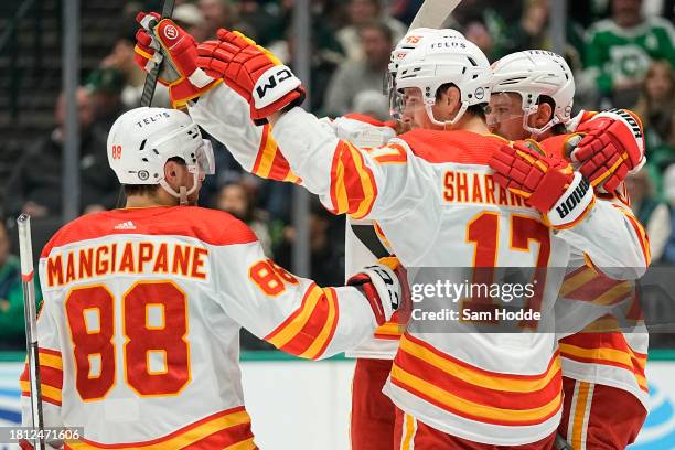 Yegor Sharangovich of the Calgary Flames celebrates with teammates after scoring a goal during the second period against the Dallas Stars at American...