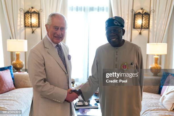 King Charles III shakes hands with Nigerian President Bola Ahmed Tinubu during a bilateral meeting on the sidelines of COP28 on November 30, 2023 in...