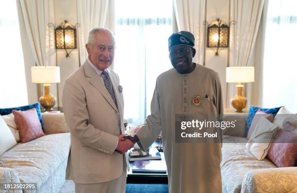 King Charles III shakes hands with Nigerian President Bola Ahmed Tinubu during a bilateral meeting on the sidelines of COP28 on November 30, 2023 in...