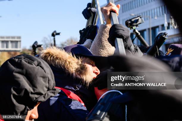 Dog farmers scuffle with police during a protest against the government's move to ban dog meat consumption, in Seoul on November 30, 2023. Hundreds...