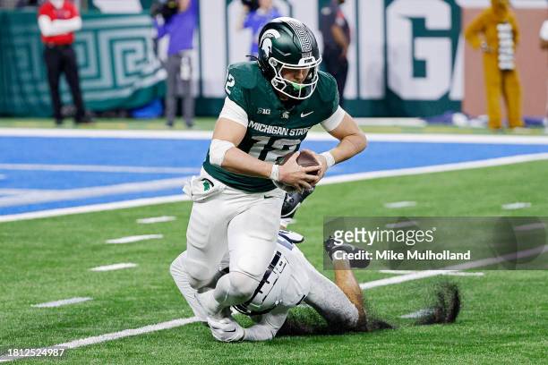 Katin Houser of the Michigan State Spartans is sacked by Cam Miller of the Penn State Nittany Lions in the fourth quarter at Ford Field on November...