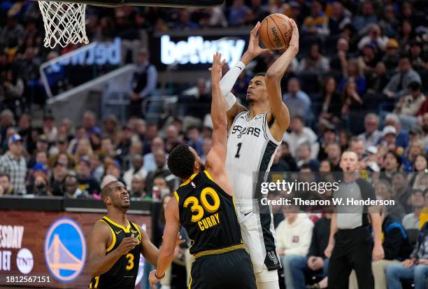 Victor Wembanyama of the San Antonio Spurs shoots the ball against Stephen Curry of the Golden State Warriors during the second quarter of the NBA...