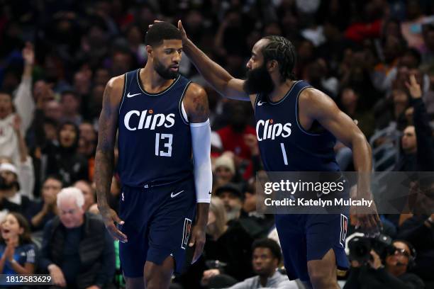 Paul George of the Los Angeles Clippers celebrates his three point basket with teammate James Harden in the second quarter against the New Orleans...