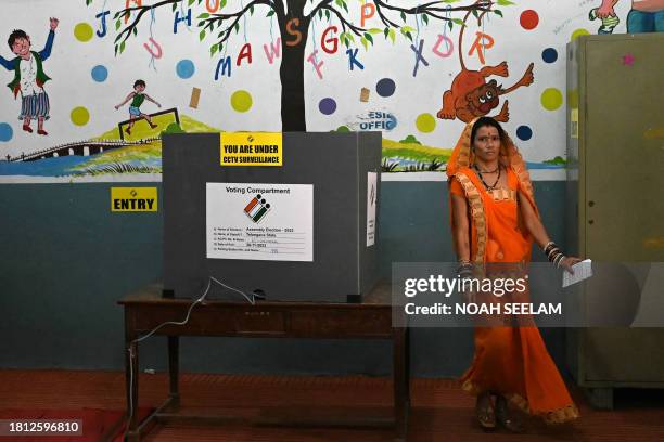 Woman leaves after casting her vote at a polling station during Telangana's state assembly elections in Hyderabad on November 30, 2023.