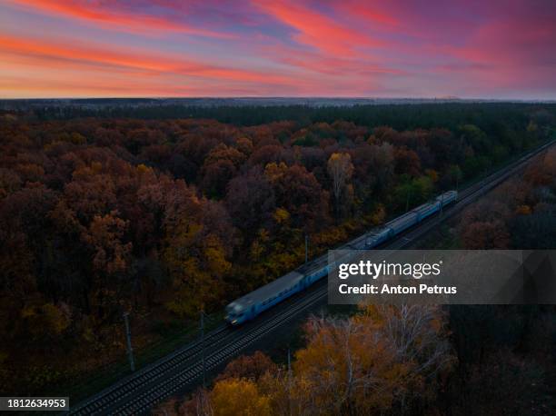 aerial view of passenger train in autumn sunset - tramway stock pictures, royalty-free photos & images