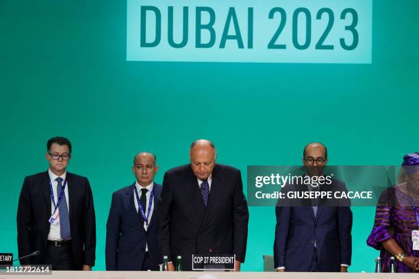 President Sameh Shoukry and other delegates observe a minute of silence for 'all civilian' killed in Gaza war during the opening ceremony of the...