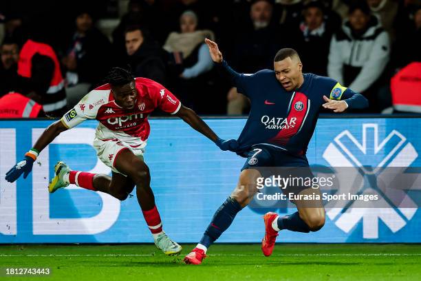 Kylian Mbappe of Paris Saint Germain is chased by Wilfried Singo of Monaco during the Ligue 1 Uber Eats match between Paris Saint-Germain and AS...