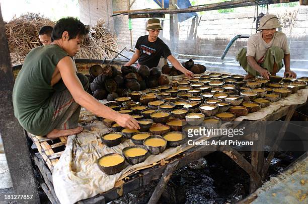 Workers making brown sugar in a small factory in Slumbung village. Most Indonesian people use brown sugar to sweeten foods and beverages. Brown sugar...