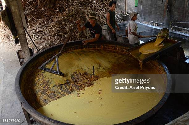 Workers making brown sugar in a small factory in Slumbung village. Most Indonesian people use brown sugar to sweeten foods and beverages. Brown sugar...