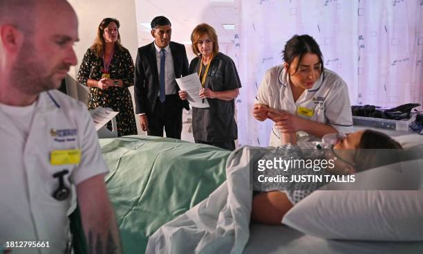 Britain's Prime Minister Rishi Sunak attends a medical demonstration, during which the mock patient is a student, as part of a visit of a medical...