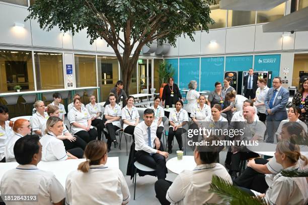 Britain's Prime Minister Rishi Sunak speaks with students is the canteen area during a visit of a medical training centre at the University of Surrey...