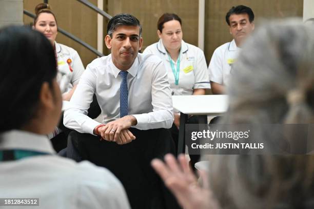 Britain's Prime Minister Rishi Sunak speaks with students is the canteen area during a visit of a medical training centre at the University of Surrey...