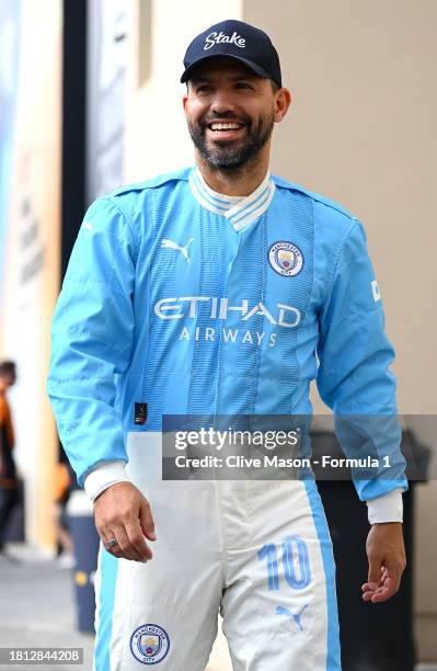 Footballer Sergio Aguero arrives in the paddock ahead of final practice ahead of the F1 Grand Prix of Abu Dhabi at Yas Marina Circuit on November 25,...