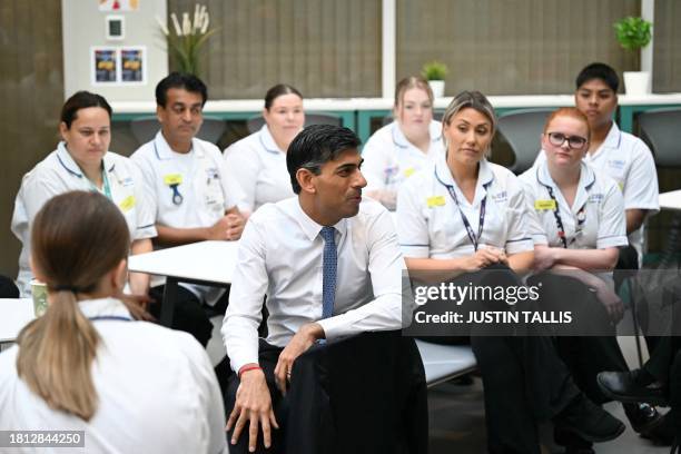 Britain's Prime Minister Rishi Sunak speaks with students is the canteen area during a visit of a medical training centre at the University of Surrey...