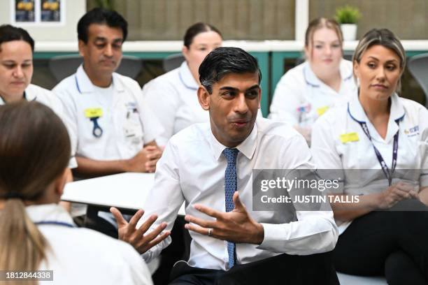 Britain's Prime Minister Rishi Sunak speaks with students is the canteen area during a visit of a medical training centre at the University of Surrey...