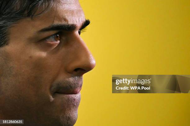 Prime Minister Rishi Sunak reacts as he speaks to journalists during a visit to a medical training centre at the University of Surrey on November 30,...