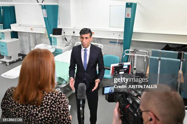 Britain's Prime Minister Rishi Sunak speaks to journalists during a visit of a medical training centre at the University of Surrey in Guildford,...