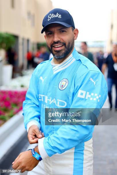 Footballer Sergio Aguero walks in the Paddock prior to final practice ahead of the F1 Grand Prix of Abu Dhabi at Yas Marina Circuit on November 25,...