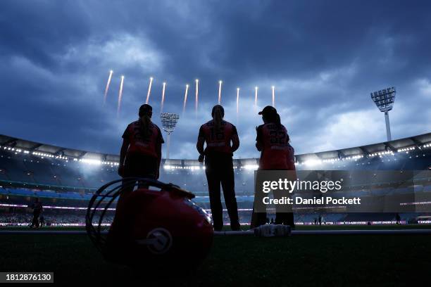 Renegades players watch the innings break entertainment during the WBBL match between Melbourne Stars and Melbourne Renegades at Melbourne Cricket...