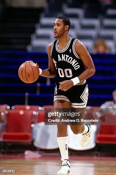 Johnny Moore of the San Antonio Spurs dribbles upcourt against the Los Angeles Clippers at the LA Sports Arena during the 1986 NBA season in Los...