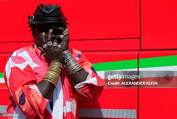 Senegalese jewelry designer "Moko" and Formula 1 enthusiast poses on September 7, 2013 in the paddock of the Circuit of Monza during the Formula One...