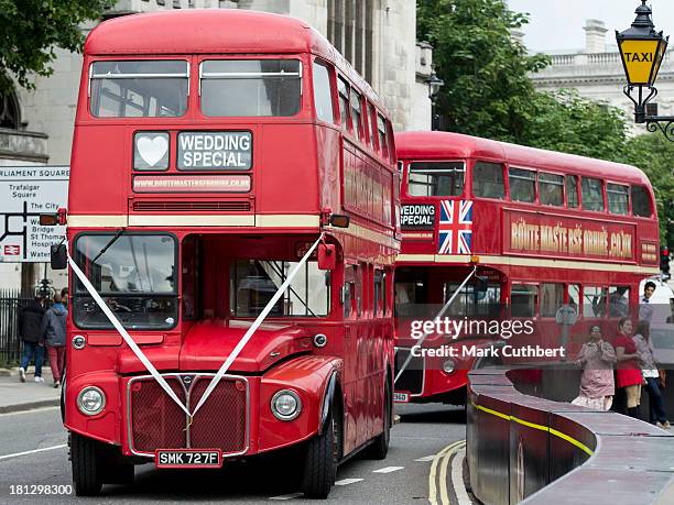 Buses wait to take the guests to the reception at the wedding of Alexander Fellowes and Alexandra Finlay at St Mary's Undercroft on September 20,...