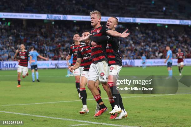 Zac Sapsford of the Wanderers celebrates with teammates after scoring the teams first goal during the A-League Men round five match between Sydney FC...