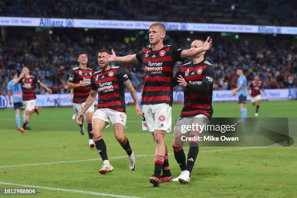 Zac Sapsford of the Wanderers celebrates with teammates after scoring the teams first goal during the A-League Men round five match between Sydney FC...