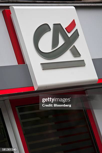 Logo sits on display outside a Credit Agricole SA bank branch in Paris, France, on Thursday, Sept. 19, 2013. Bank of France General Council member...