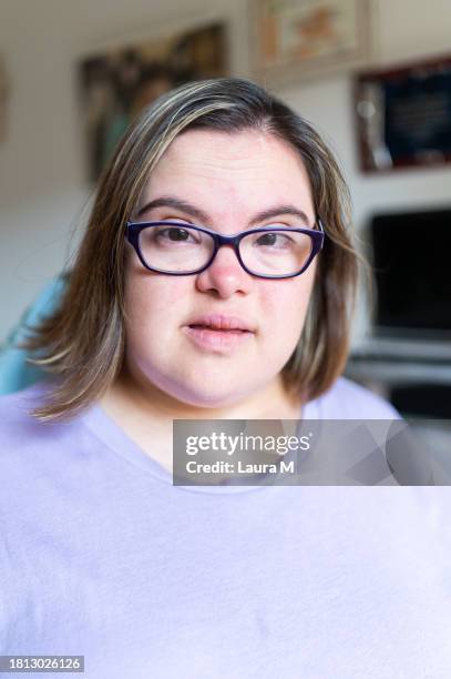 close-up of a cute woman with down syndrome at home - developmental disability stock pictures, royalty-free photos & images