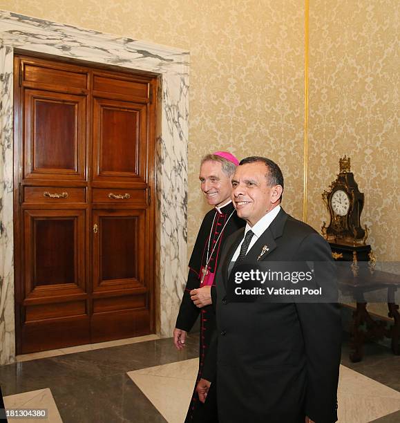 Honduras President Porfirio Lobo Sosa, flanked by Prefect of the Pontifical House and former personal secretary of Pope Benedict XVI Georg Ganswein ,...