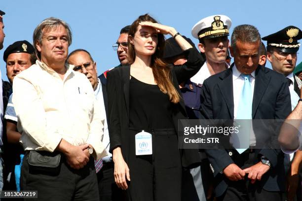 Actress Angelina Jolie looks on next to United Nations High Commissioner for Refugees Antonio Guterres during a visit to the Italian island of...