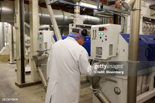 Worker inspects a sample of rice in a milling machine at the Veetee Rice Ltd. Facility in Rochester, UK, on Wednesday, Aug. 9, 2023. British rice...