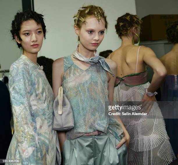 Models pose backstage ahead of the Emporio Armani show as a part of Milan Fashion Week Womenswear Spring/Summer 2014 on September 20, 2013 in Milan,...