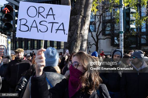 An activist holds a placard reading "It's enough" as she takes part in the demonstration "Il Patriarcato Uccide" , demanding the elimination of...