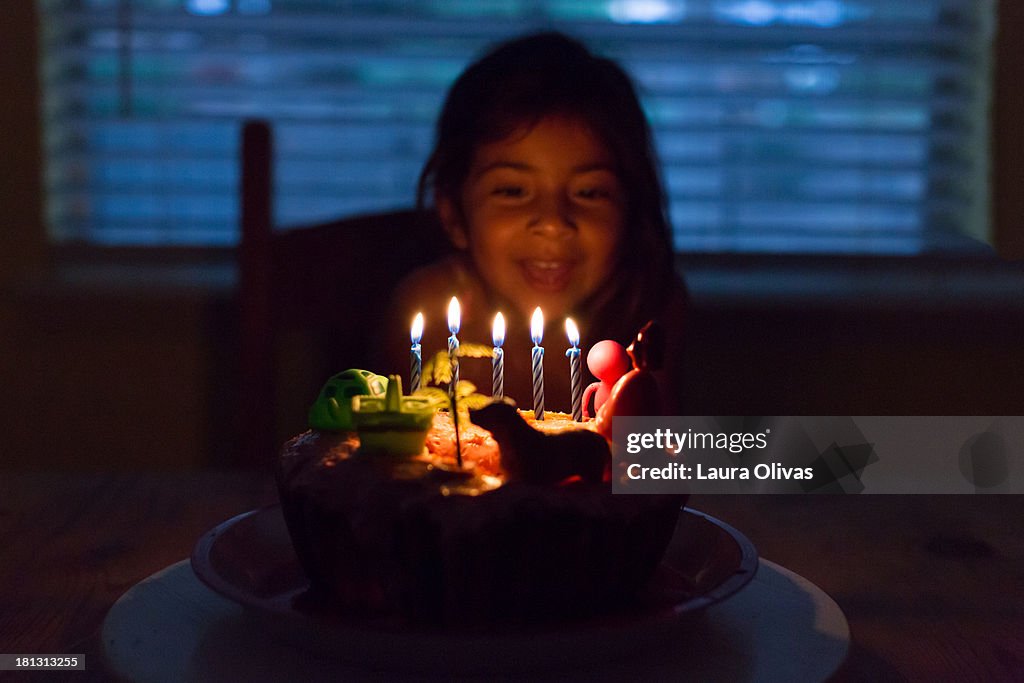 Girl with wildly decorated birthday cake