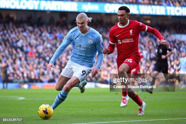 Erling Haaland of Manchester City and Trent Alexander-Arnold of Liverpool battle for possession during the Premier League match between Manchester...