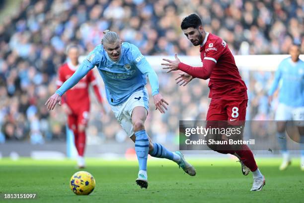 Erling Haaland of Manchester City runs with the ball whilst under pressure from Dominik Szoboszlai of Liverpool during the Premier League match...