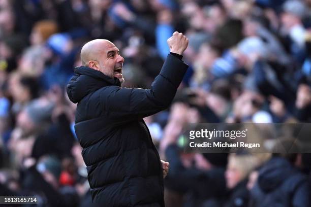 Pep Guardiola, Manager of Manchester City, celebrates after Erling Haaland scores the team's first goal during the Premier League match between...