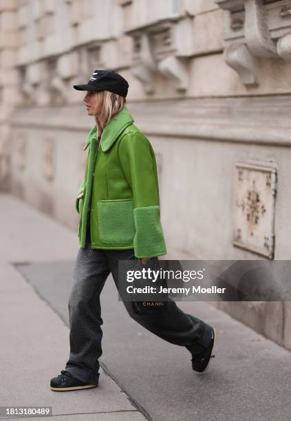 Karin Teigl seen wearing Cole Buxton black logo cap, Baum & Pferdgarten green leather jacket with fake fur details / collar and sleeves, H&M grey...