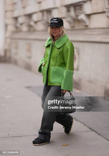 Karin Teigl seen wearing Cole Buxton black logo cap, Baum & Pferdgarten green leather jacket with fake fur details / collar and sleeves, H&M grey...