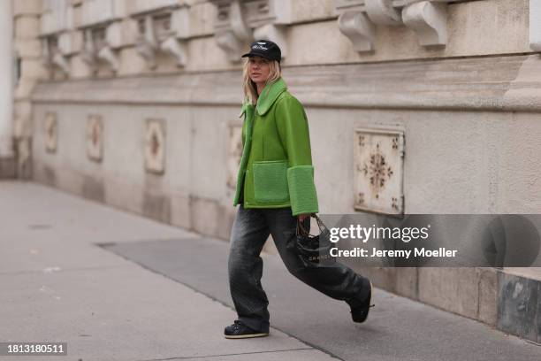 Karin Teigl seen wearing Cole Buxton black logo cap, Baum & Pferdgarten green leather jacket with fake fur details / collar and sleeves, H&M grey...