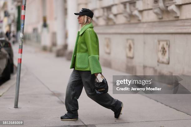 Karin Teigl seen wearing Cole Buxton black logo cap, Baum & Pferdgarten green leather jacket with fake fur details / collar and sleeves, H&M grey...