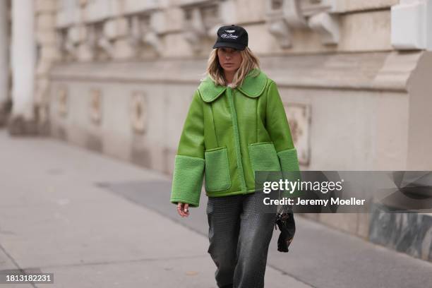 Karin Teigl seen wearing Cole Buxton black logo cap, Baum & Pferdgarten green leather jacket with fake fur details / collar and sleeves, H&M grey...