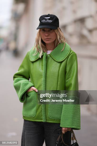 Karin Teigl seen wearing Cole Buxton black logo cap, Baum & Pferdgarten green leather jacket with fake fur details / collar and sleeves, H&M grey...