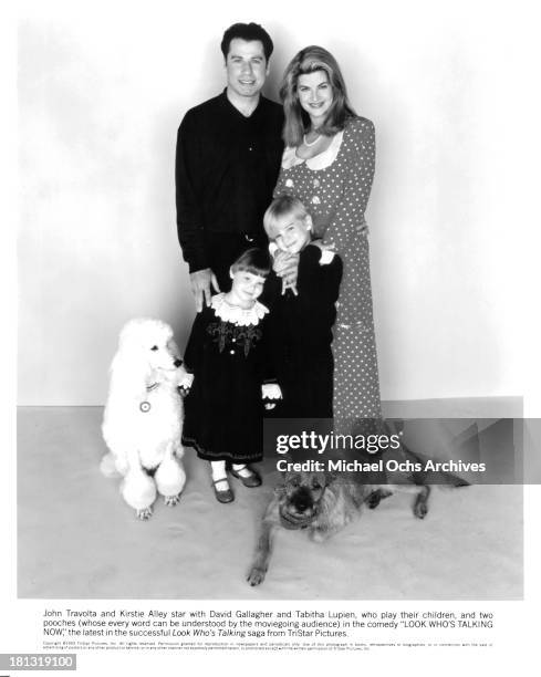 Actor John Travolta with actress Kirstie Alley with David Gallagher and Tabitha Lupien pose for the Tri Star movie " Look Who's Talking Now " in 1993.