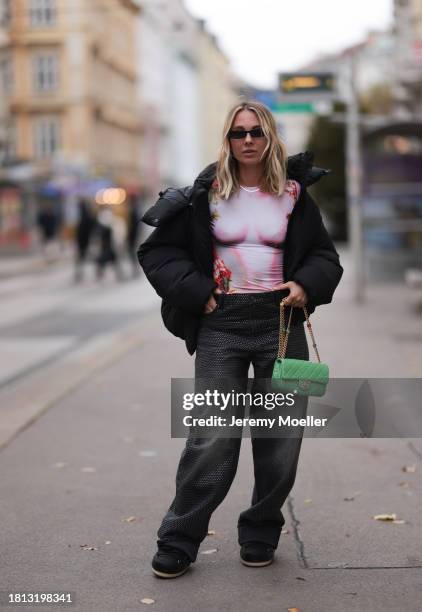 Karin Teigl seen wearing black sunglasses, KHY by Kylie Jenner black puffer / down jacket, H&M Studios grey sparkling wide leg jeans / denim pants,...