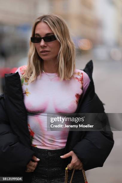 Karin Teigl seen wearing black sunglasses, KHY by Kylie Jenner black puffer / down jacket, H&M Studios grey sparkling wide leg jeans / denim pants,...