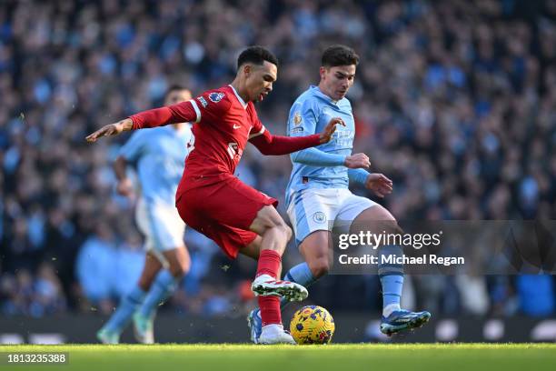 Trent Alexander-Arnold of Liverpool and Julian Alvarez of Manchester City battle for possession during the Premier League match between Manchester...