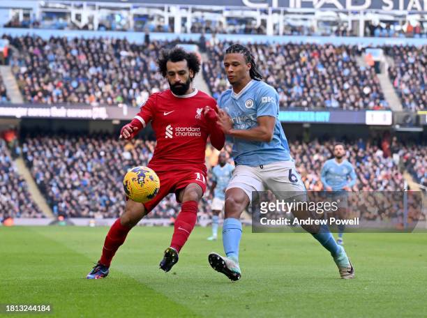 Mohamed Salah of Liverpool competing with Nathan Ake of Manchester City during the Premier League match between Manchester City and Liverpool FC at...